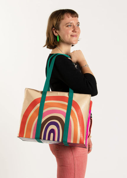 Blue Q Rainbow Shoulder Tote is the carry-everywhere bag featuring a hefty zipper, exterior pocket, wrap-around straps, reinforced floor, 95% recycled material, 11" h x 15" w x 6.25" d